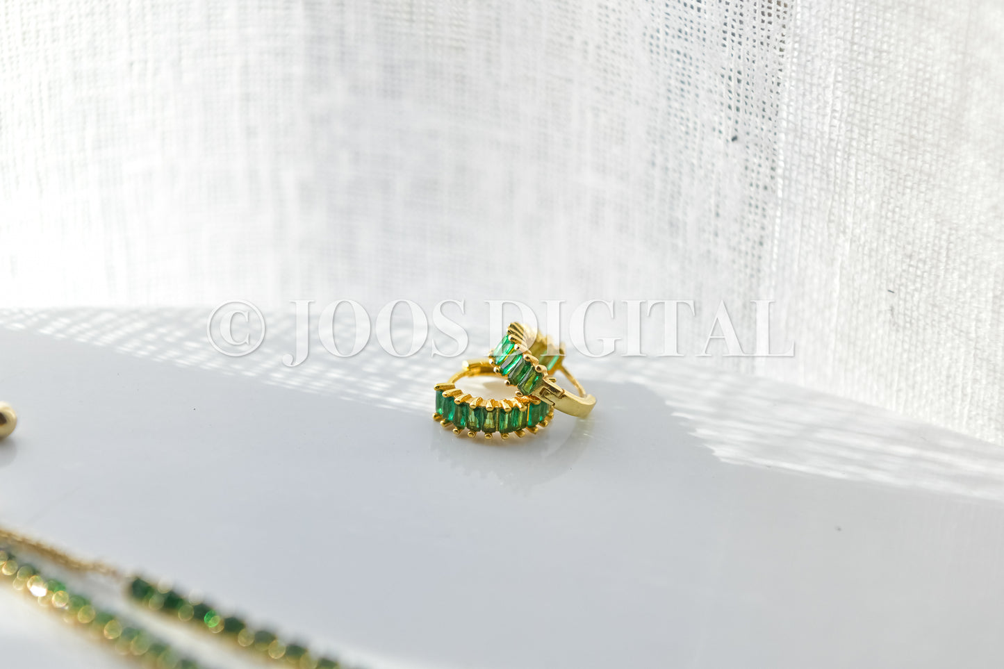 Emerald Earrings On White Table