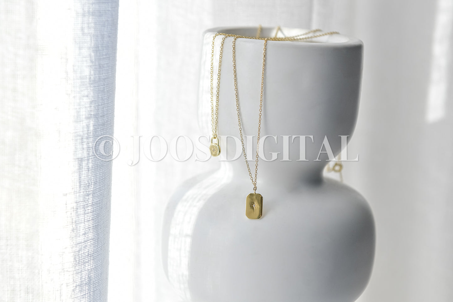 Gold Necklaces On White Vase